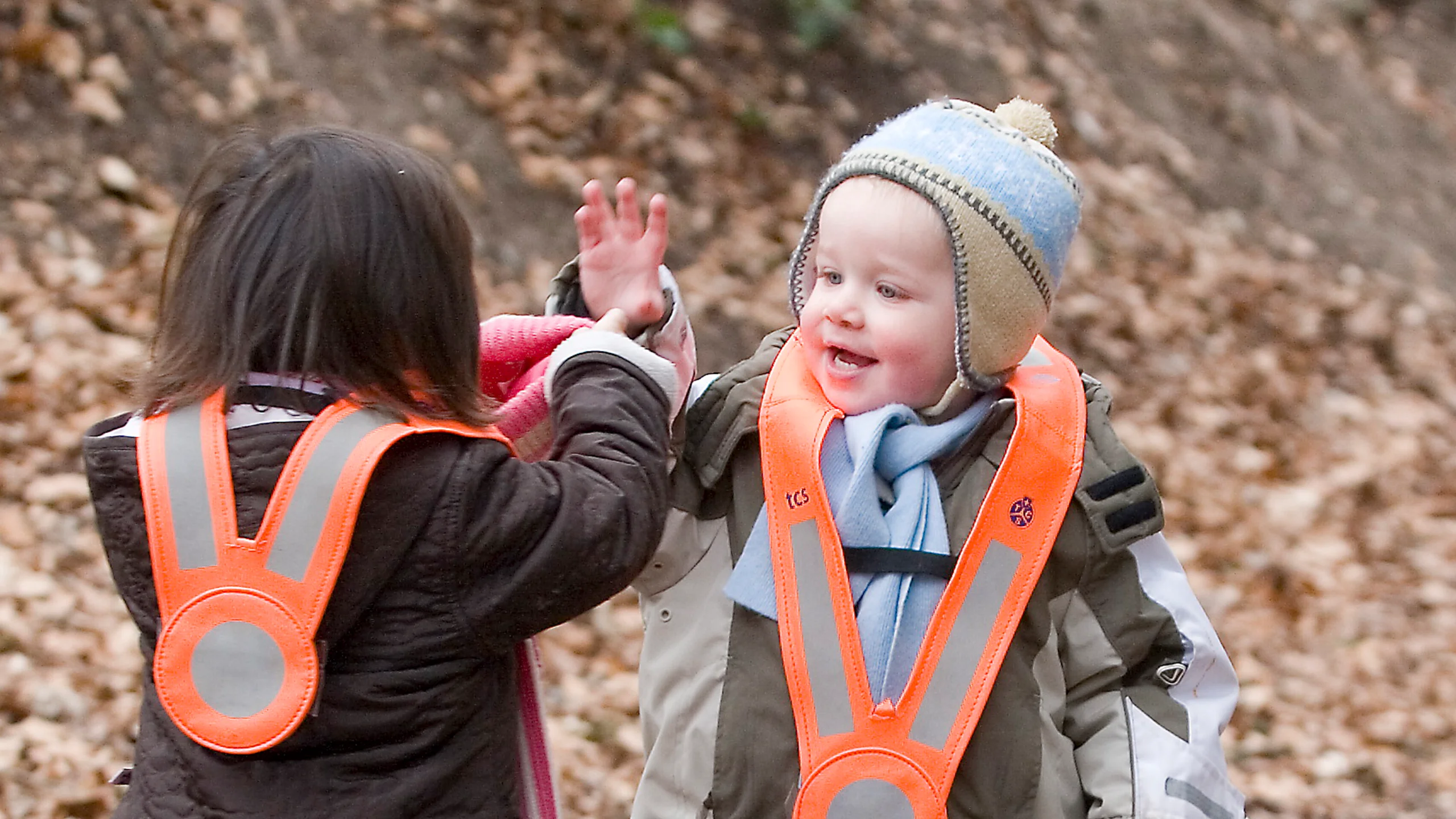 Toddlers experience nature and the outdoors playfully.